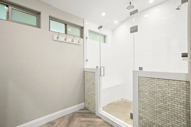 a bathroom with a shower and a sink