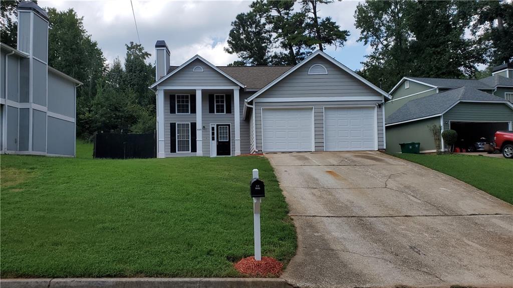 5575 Downs Way Lithonia, GA 30058 - Photo 1 of 1 a front view of a house with a garden