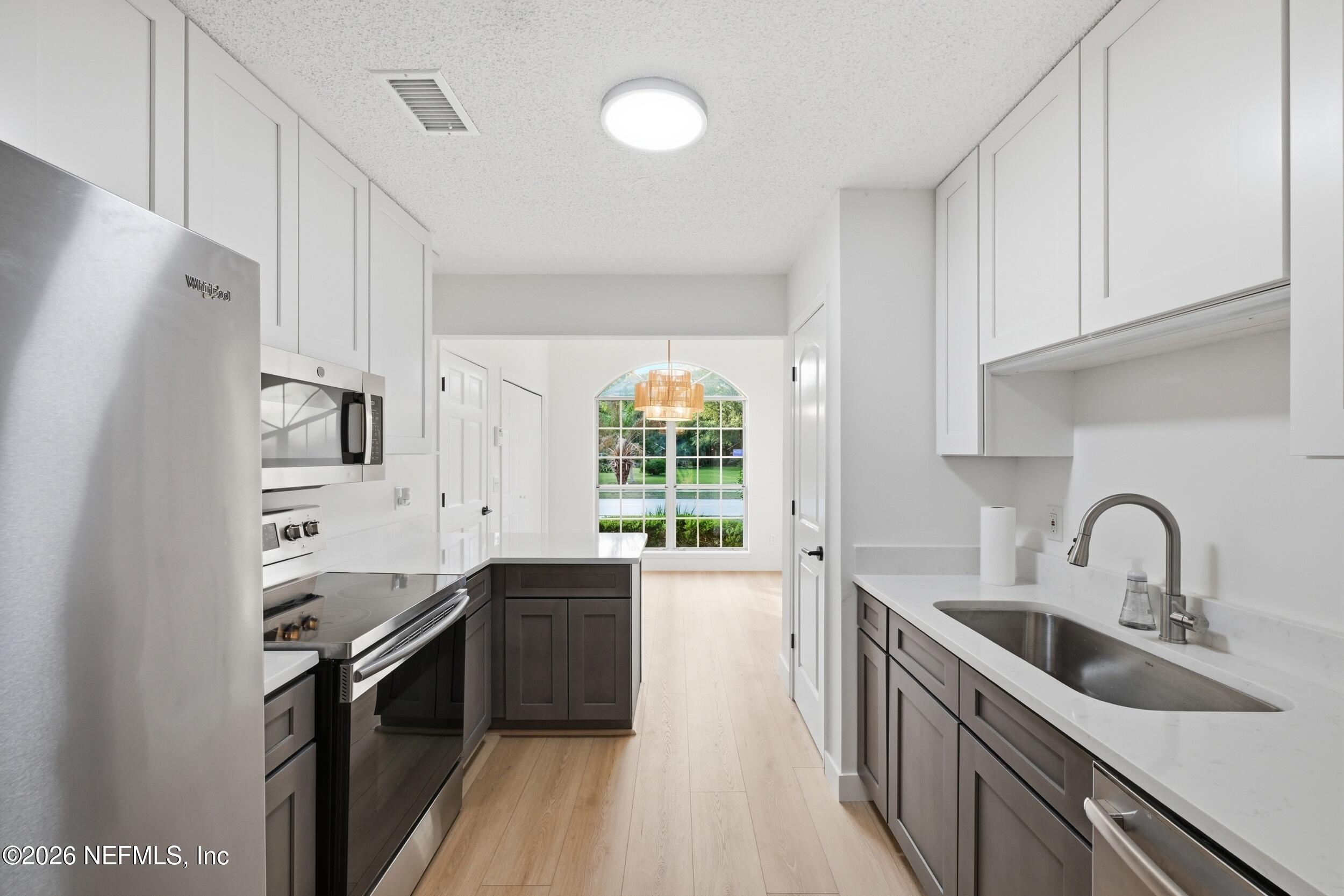 3286 Marbon Road Jacksonville, FL 32223 - Photo 16 of 36 a kitchen with a sink stove and refrigerator
