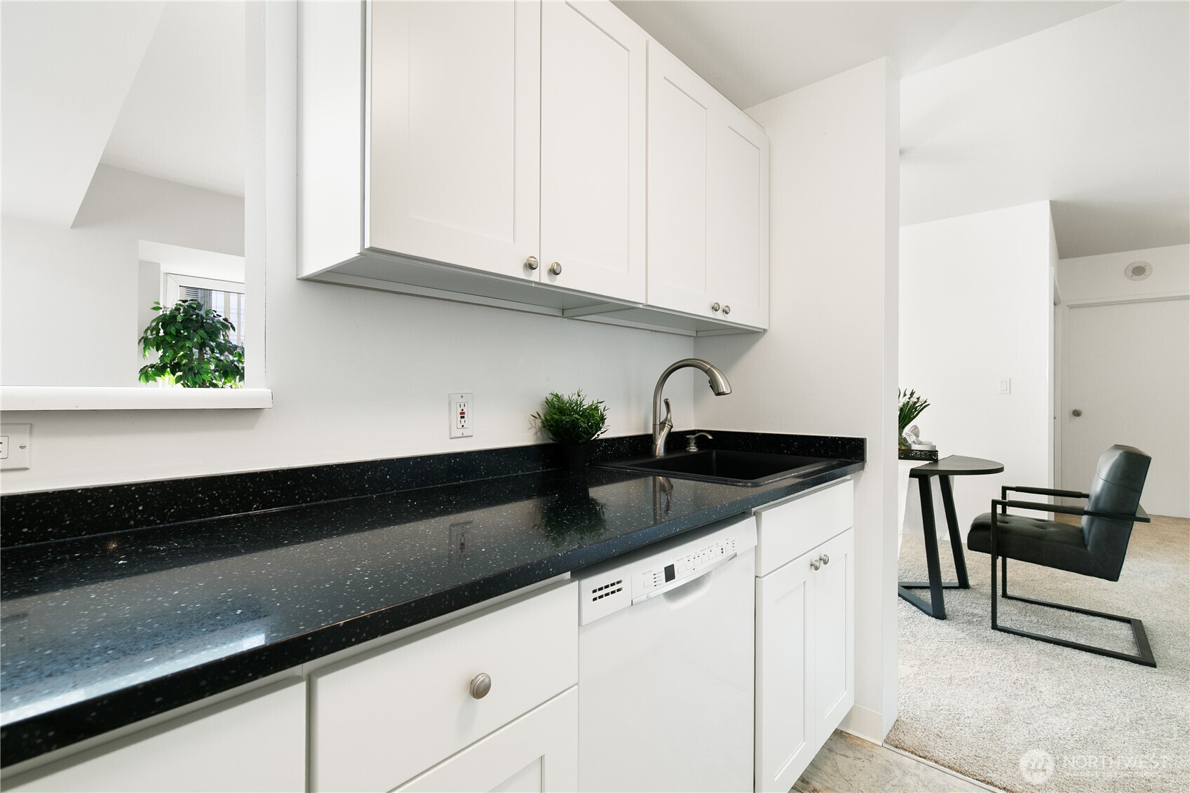 1415 2nd Avenue, Unit 1607 Seattle, WA 98101 - Photo 14 of 40 a kitchen with granite countertop a sink a stove and cabinets