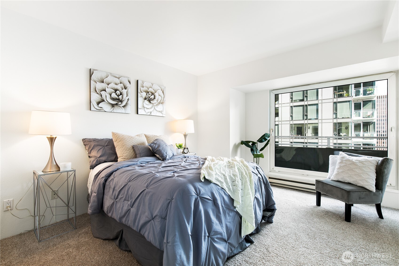 1415 2nd Avenue, Unit 1607 Seattle, WA 98101 - Photo 16 of 40 a bed room with a bed and a chair