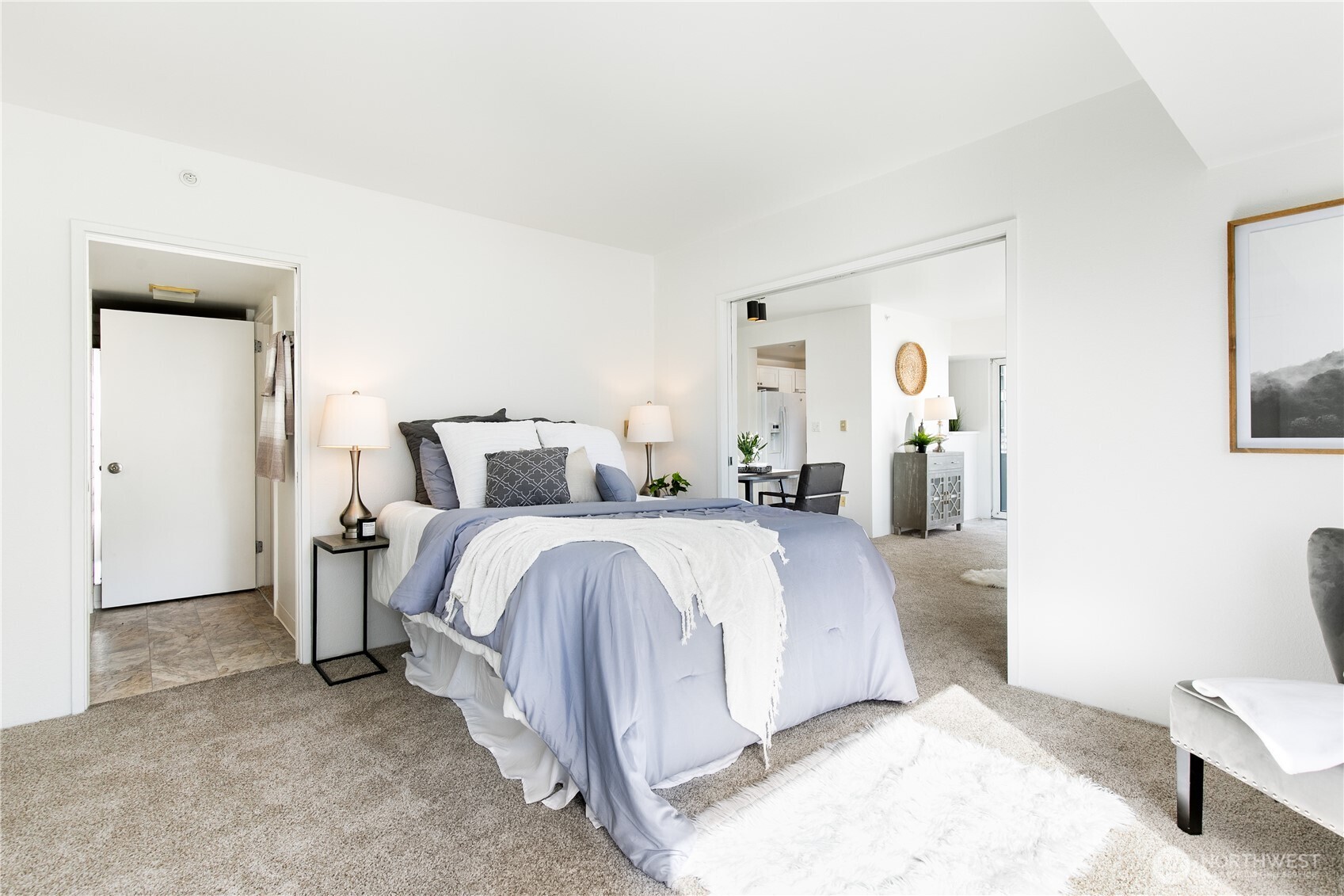 1415 2nd Avenue, Unit 1607 Seattle, WA 98101 - Photo 20 of 40 a bedroom with a bed and a lamp