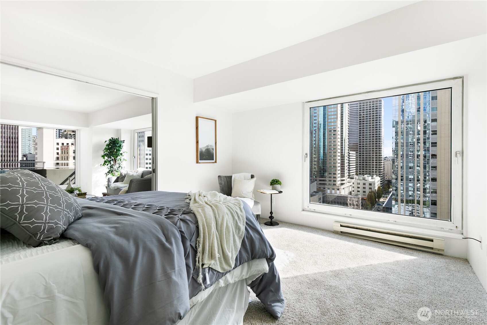 1415 2nd Avenue, Unit 1607 Seattle, WA 98101 - Photo 21 of 40 a spacious bedroom with a large bed and a large window