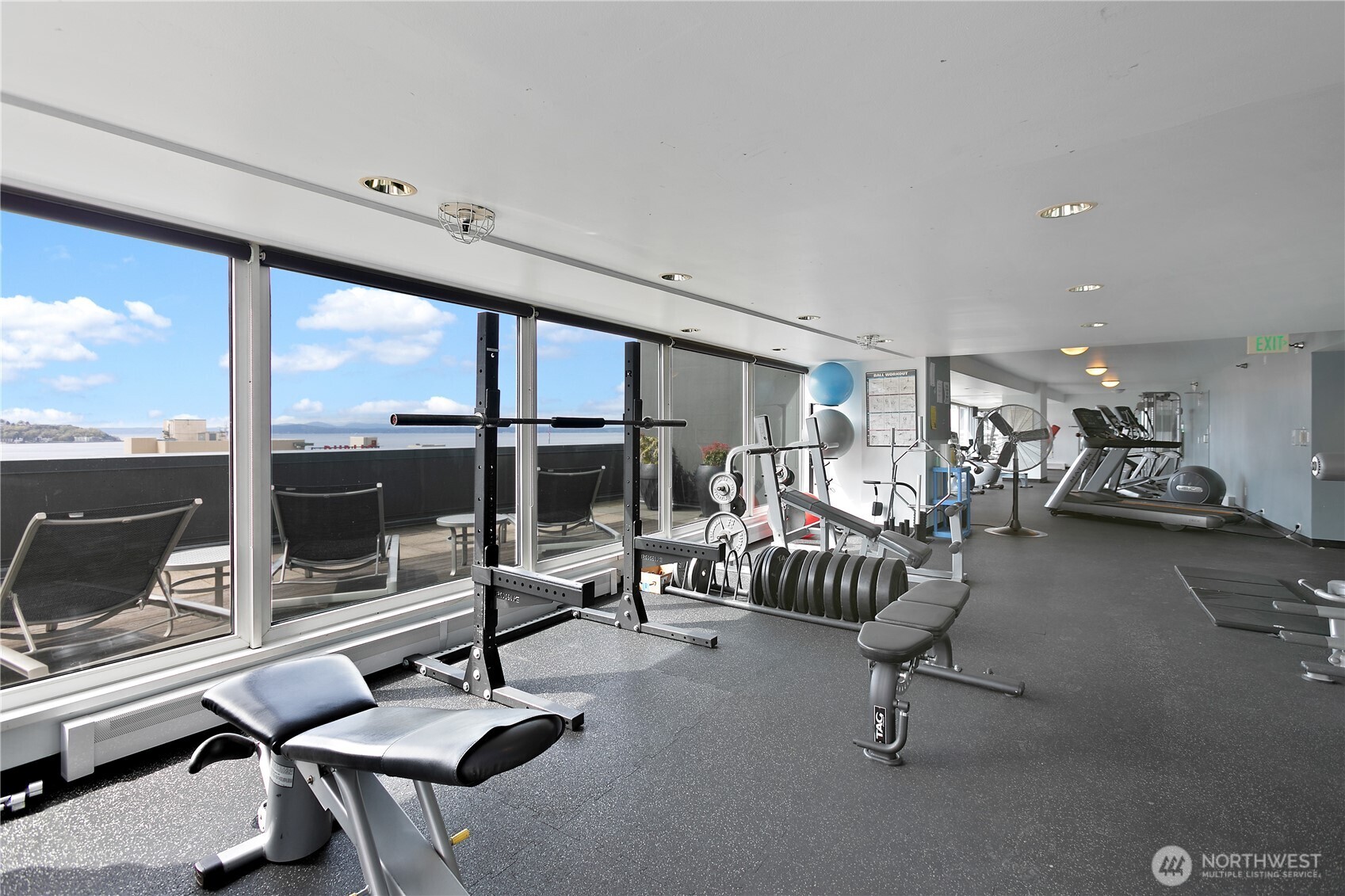 1415 2nd Avenue, Unit 1607 Seattle, WA 98101 - Photo 30 of 40 a living room with furniture gym equipment and a large window