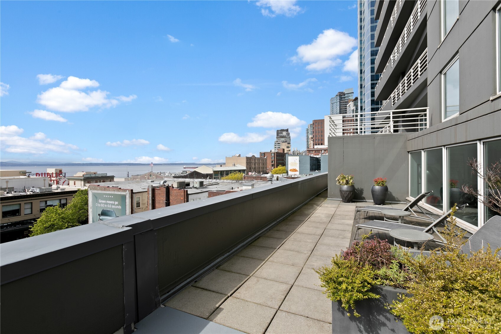 1415 2nd Avenue, Unit 1607 Seattle, WA 98101 - Photo 32 of 40 a terrace with outdoor seating and city view