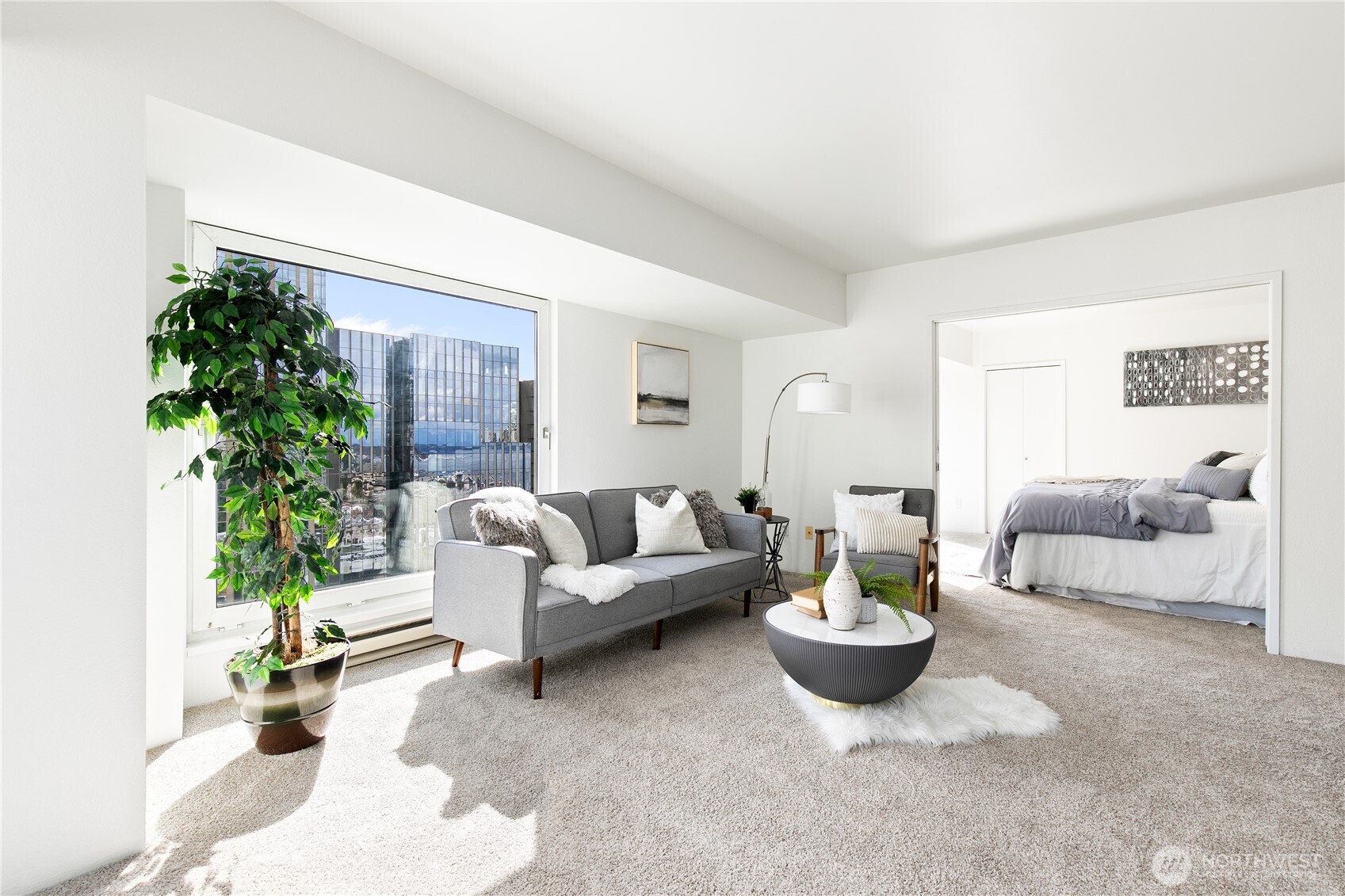 1415 2nd Avenue, Unit 1607 Seattle, WA 98101 - Photo 5 of 40 a living room with furniture potted plant and a window