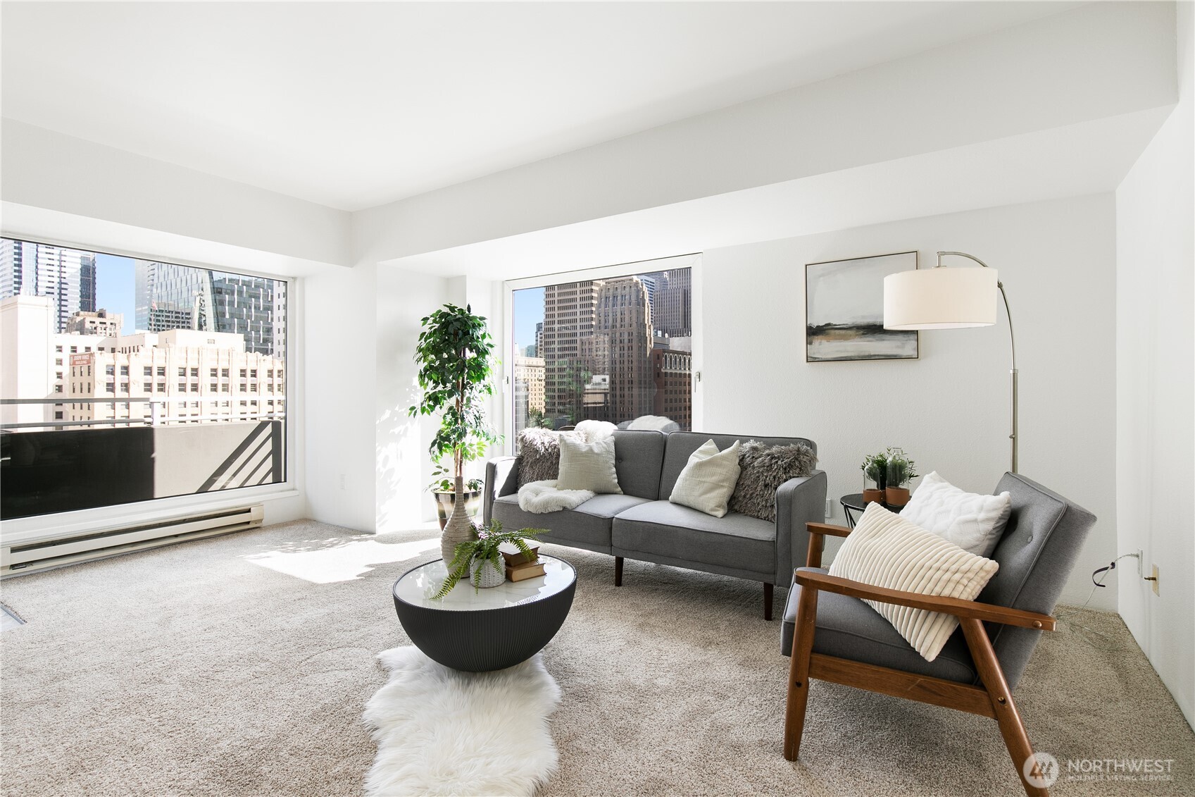 1415 2nd Avenue, Unit 1607 Seattle, WA 98101 - Photo 7 of 40 a living room with furniture and a potted plant