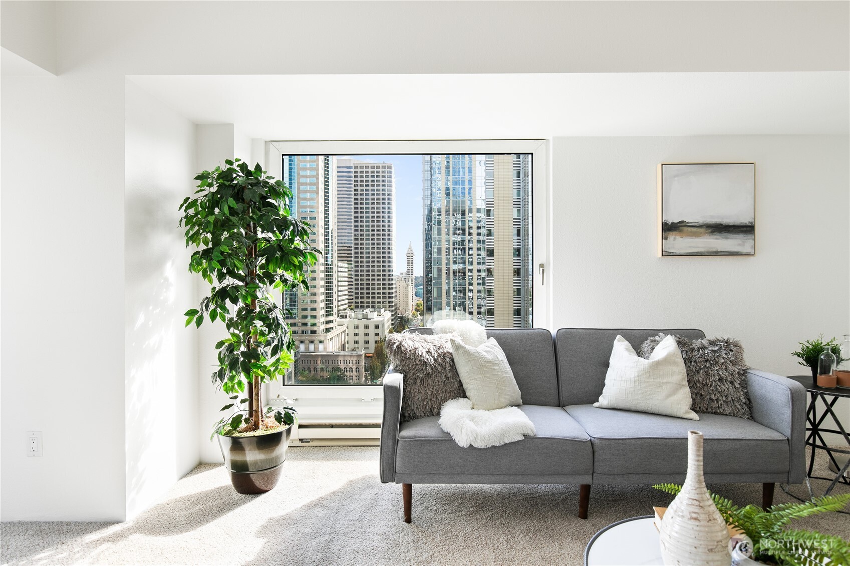 1415 2nd Avenue, Unit 1607 Seattle, WA 98101 - Photo 8 of 40 a living room with furniture and a potted plant
