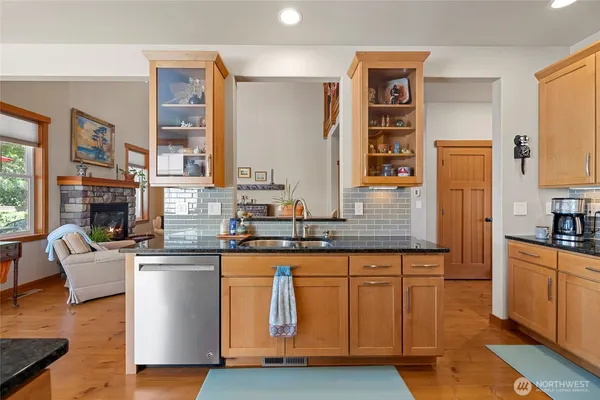a kitchen with stainless steel appliances granite countertop a stove and cabinets