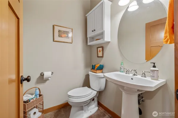 a bathroom with a sink mirror and toilet