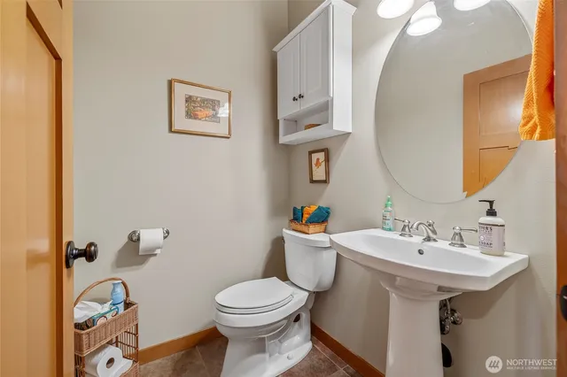 a bathroom with a sink mirror and toilet