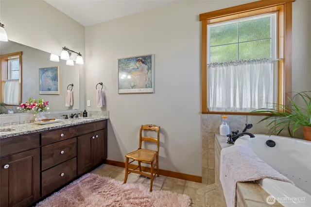 a bathroom with a granite countertop sink mirror and double