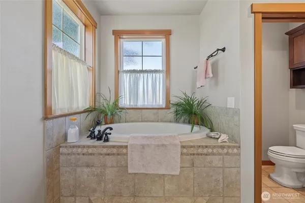 a bedroom with a bed window and a table