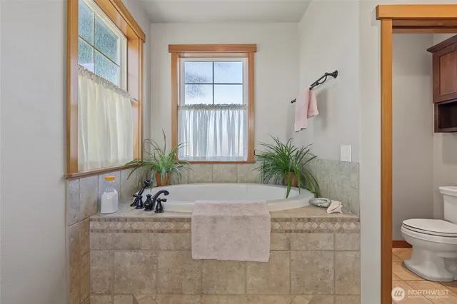 a bedroom with a bed window and a table