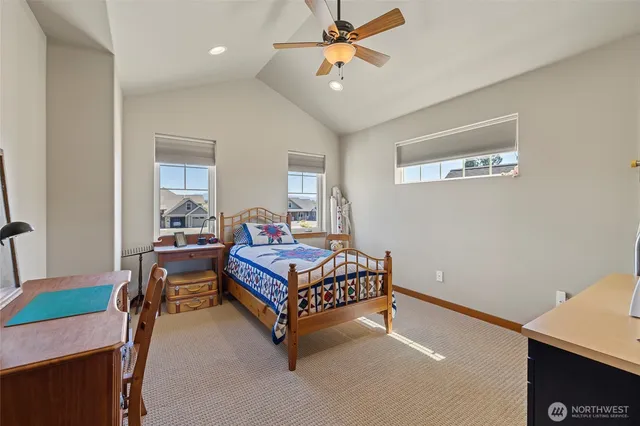 a bathroom with a granite countertop sink mirror vanity and a toilet