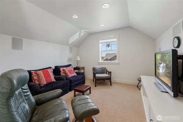 a living room with furniture and a book shelf