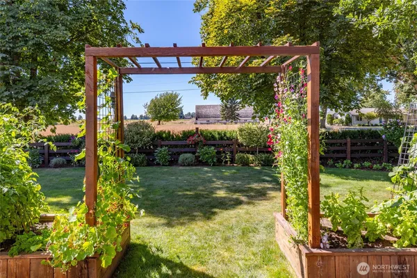 a patio with a table and chairs under an umbrella