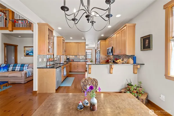 a living room with kitchen island furniture and a chandelier