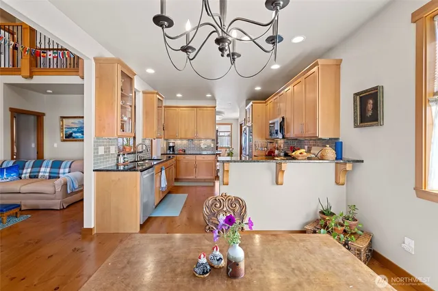 a living room with kitchen island furniture and a chandelier