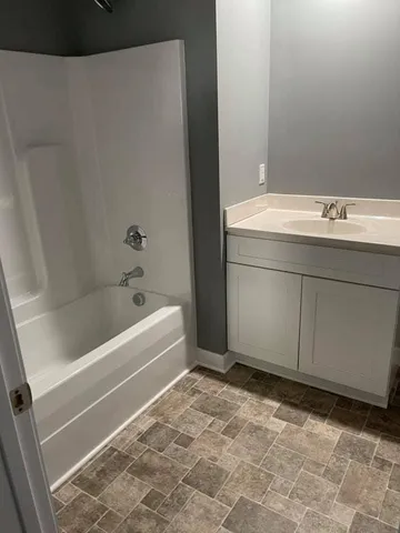 a bathroom with a bathtub and a sink