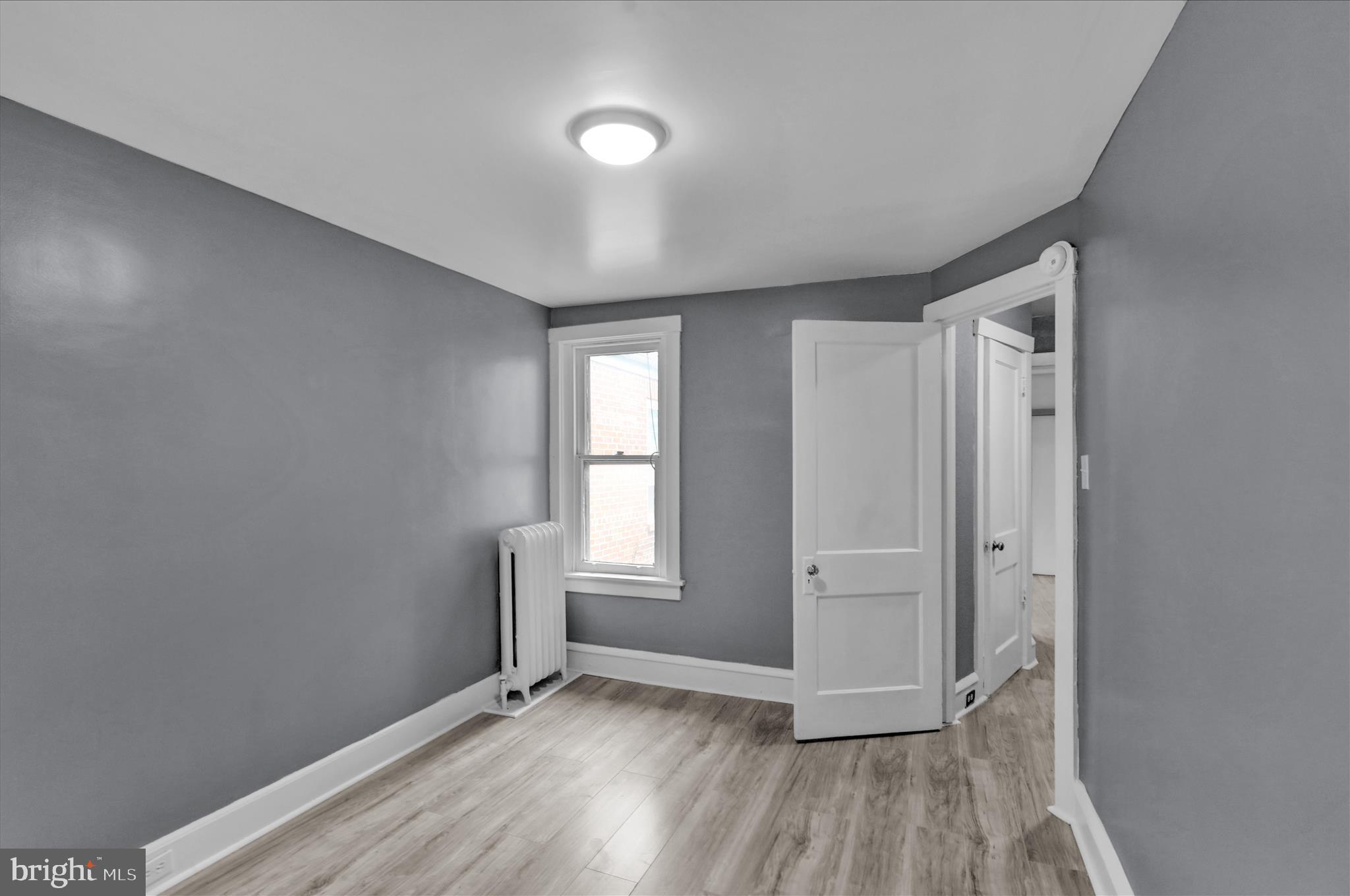 1409 Church Street Reading, PA 19601 - Photo 20 of 23 an empty room with wooden floor and windows