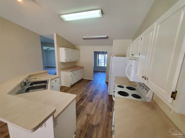 a kitchen with stainless steel appliances a stove a sink and a refrigerator