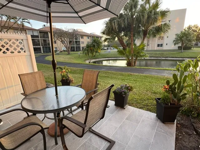 a view of a patio with a table and chairs