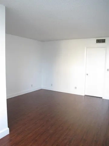 an empty room with wooden floor