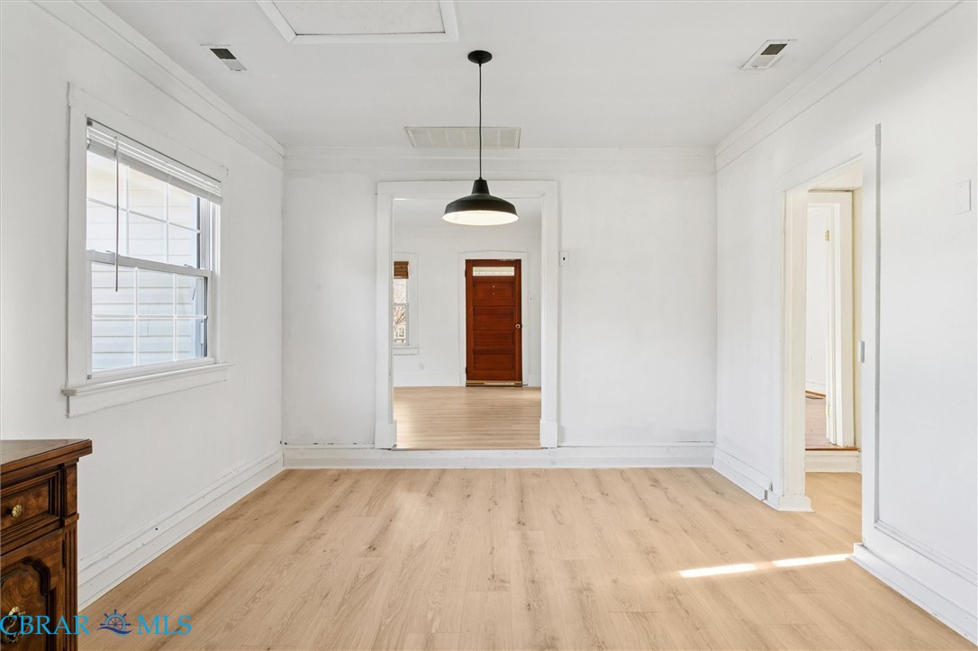 2290 Hayes Road Hayes, VA 23072 - Photo 16 of 32 Unfurnished dining area featuring light wood-style floors and crown molding