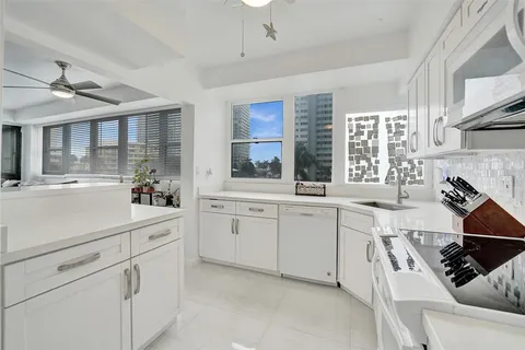 a kitchen with cabinets and stainless steel appliances