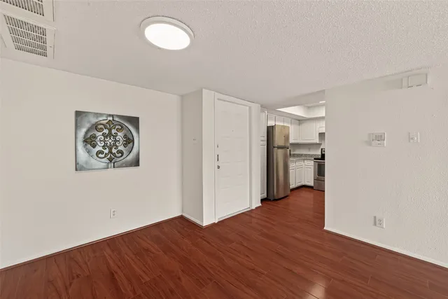 a view of a room with wooden floor and closet