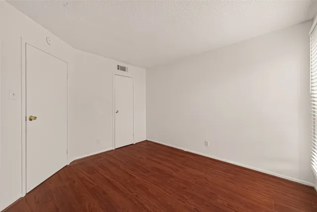 a view of a room with wooden floor