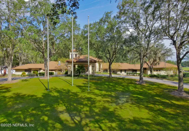 a view of green field with sitting area