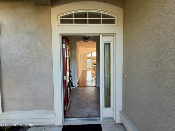 a view of a hallway with wooden floor and entryway