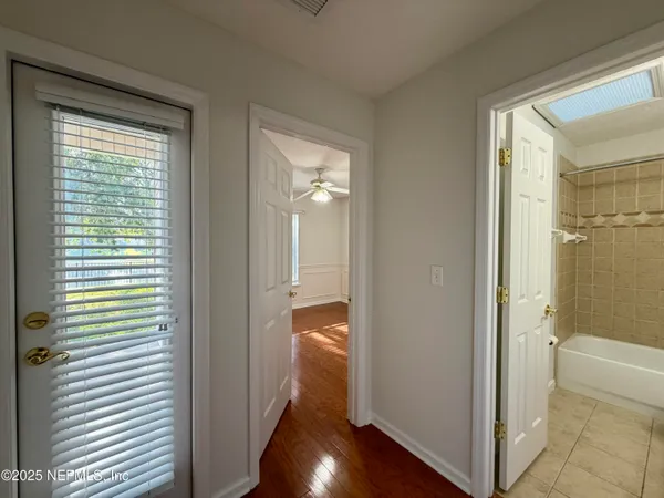 a view of a bathroom with a tub and shower