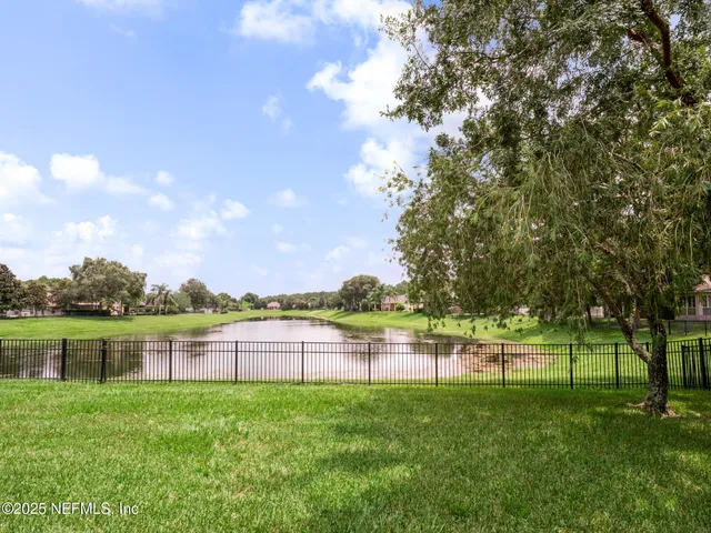 a view of a lake with houses in the back