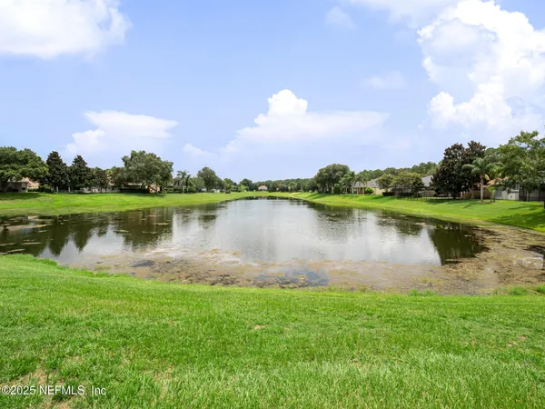 a view of a lake with houses in the back