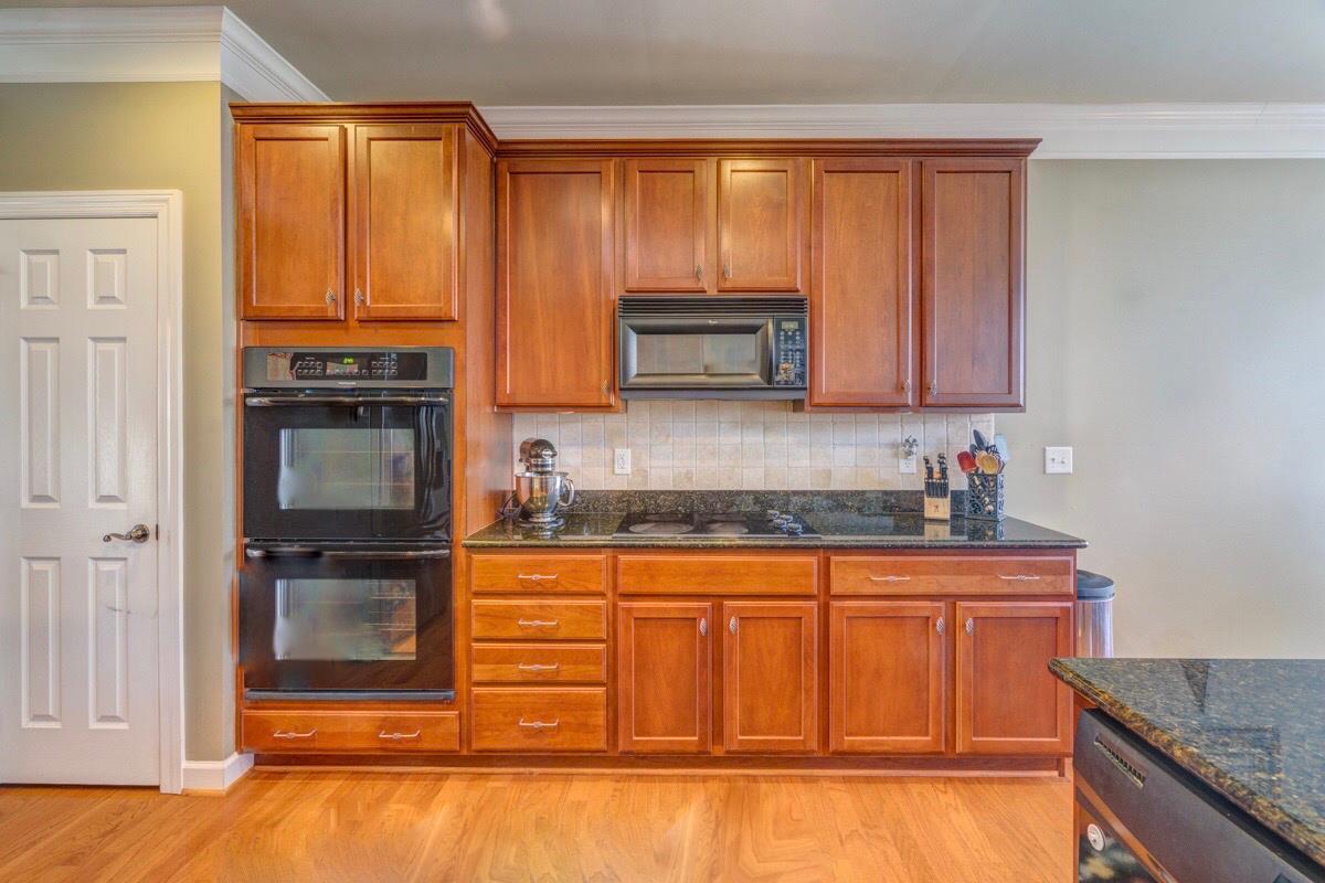 3537 Trimble Road Nashville, TN 37215 - Photo 14 of 29 a kitchen with granite countertop a stove top oven microwave and cabinets