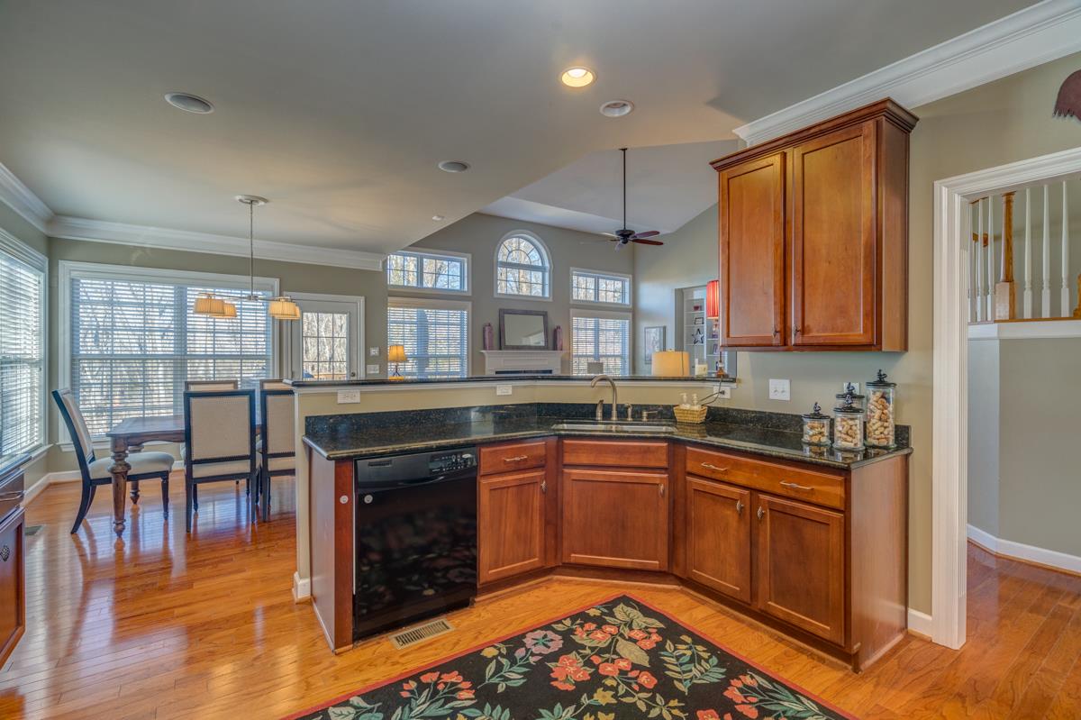 3537 Trimble Road Nashville, TN 37215 - Photo 15 of 29 a kitchen with stainless steel appliances granite countertop a stove top oven a sink dishwasher and a dining table with wooden floor