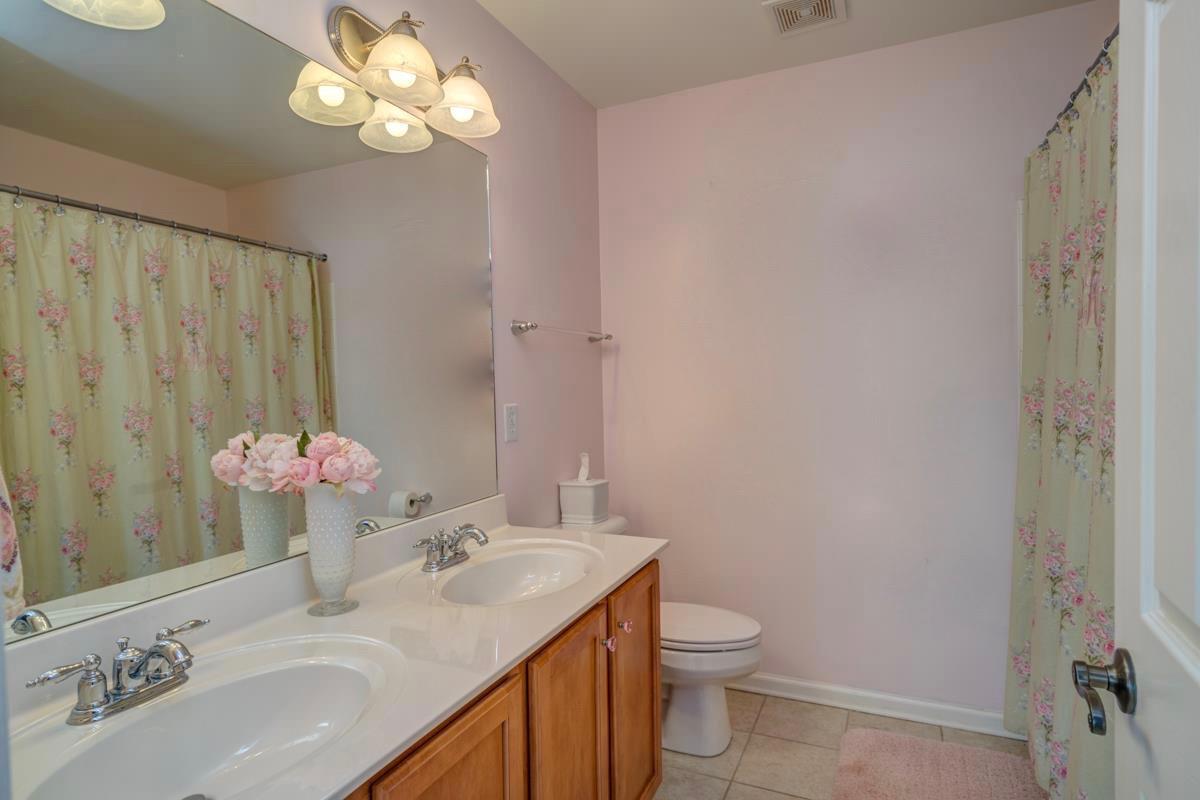 3537 Trimble Road Nashville, TN 37215 - Photo 23 of 29 a bathroom with a granite countertop sink a toilet and a mirror