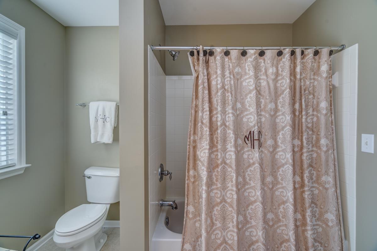 3537 Trimble Road Nashville, TN 37215 - Photo 25 of 29 a white toilet sitting next to a shower curtain