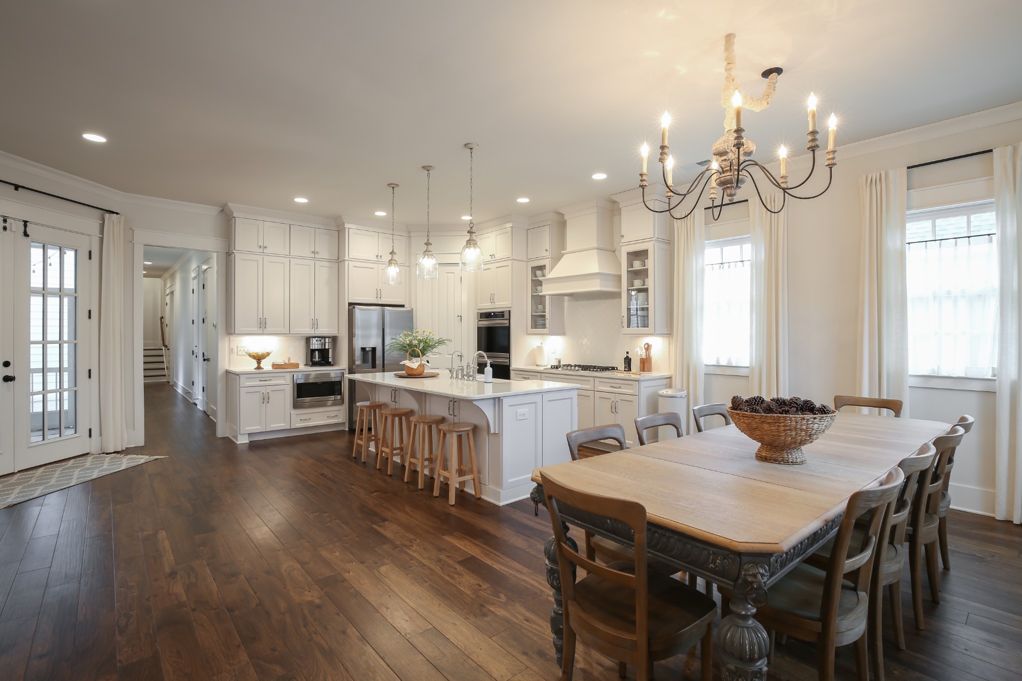 237 Stephens Valley Boulevard Nashville, TN 37221 - Photo 2 of 34 a kitchen with a dining table chairs wooden floor appliances and cabinets
