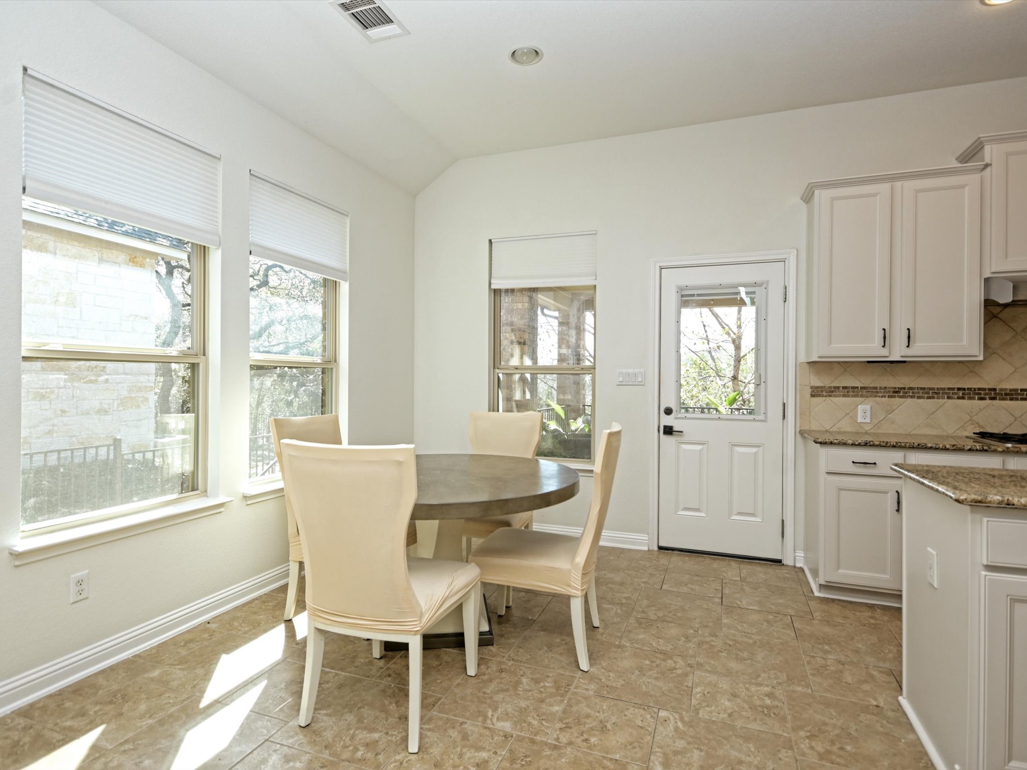 201 Bellagio Drive Austin, TX 78734 - Photo 13 of 31 The sunny dining area offers walkout access to the entertainer's back porch making it easy to grill out and dine in.