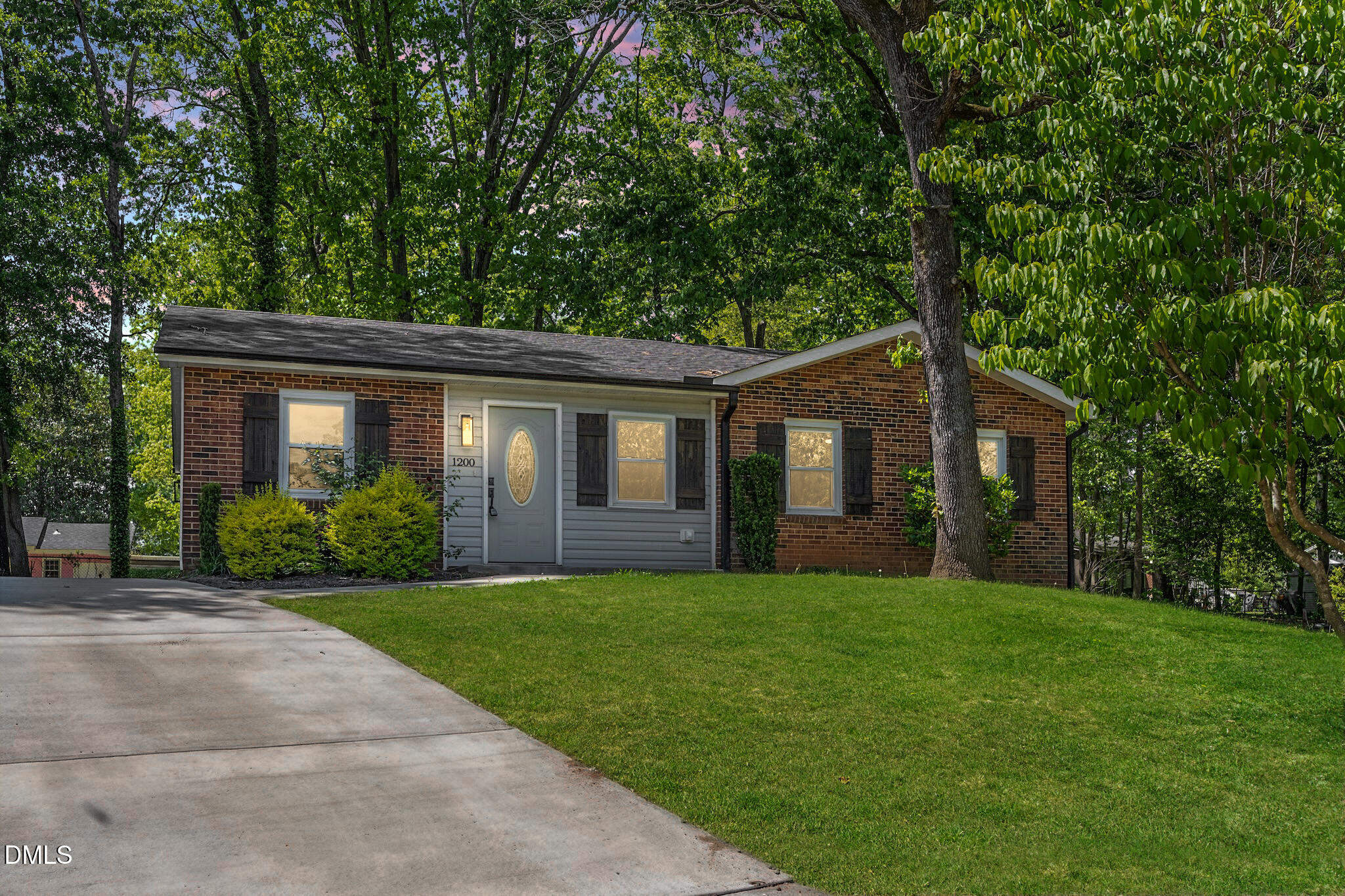 a front view of a house with yard and green space