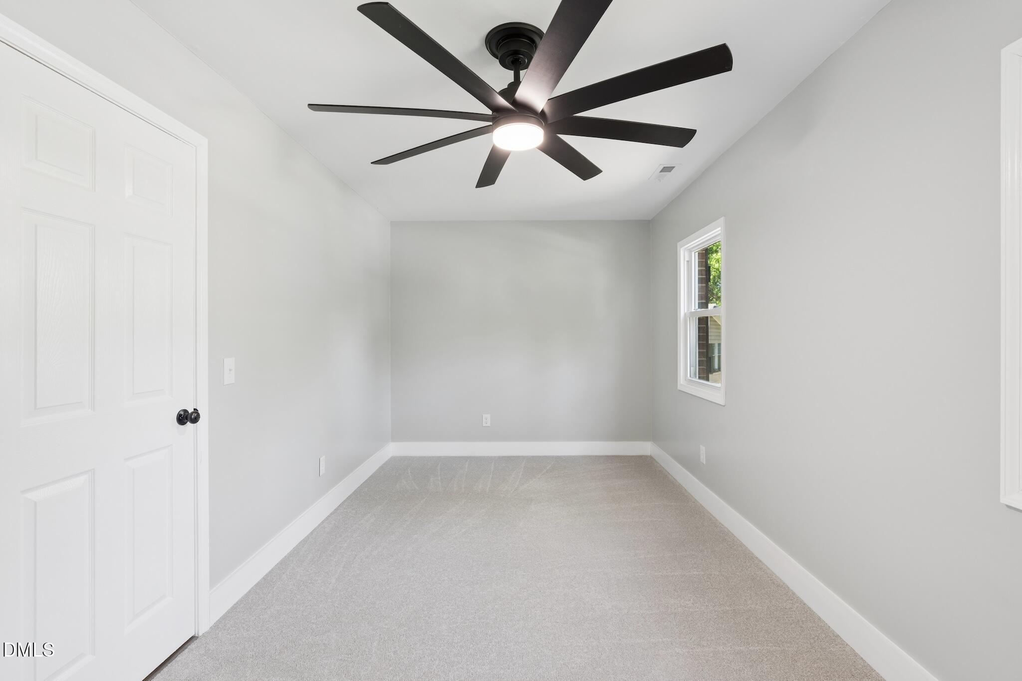 1200 Armstrong Circle Raleigh, NC 27610 - Photo 19 of 28 an empty room with ceiling fan and windows