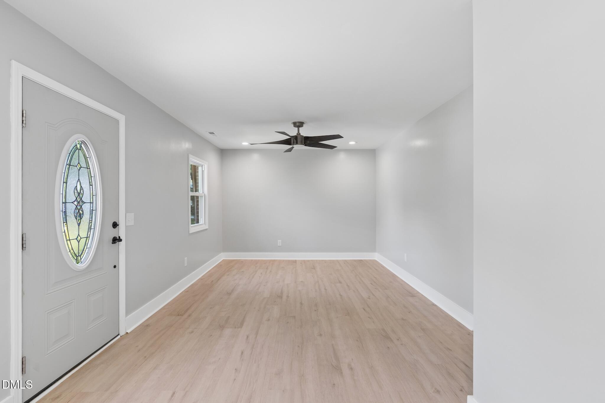 1200 Armstrong Circle Raleigh, NC 27610 - Photo 5 of 28 an empty room with windows and mirror