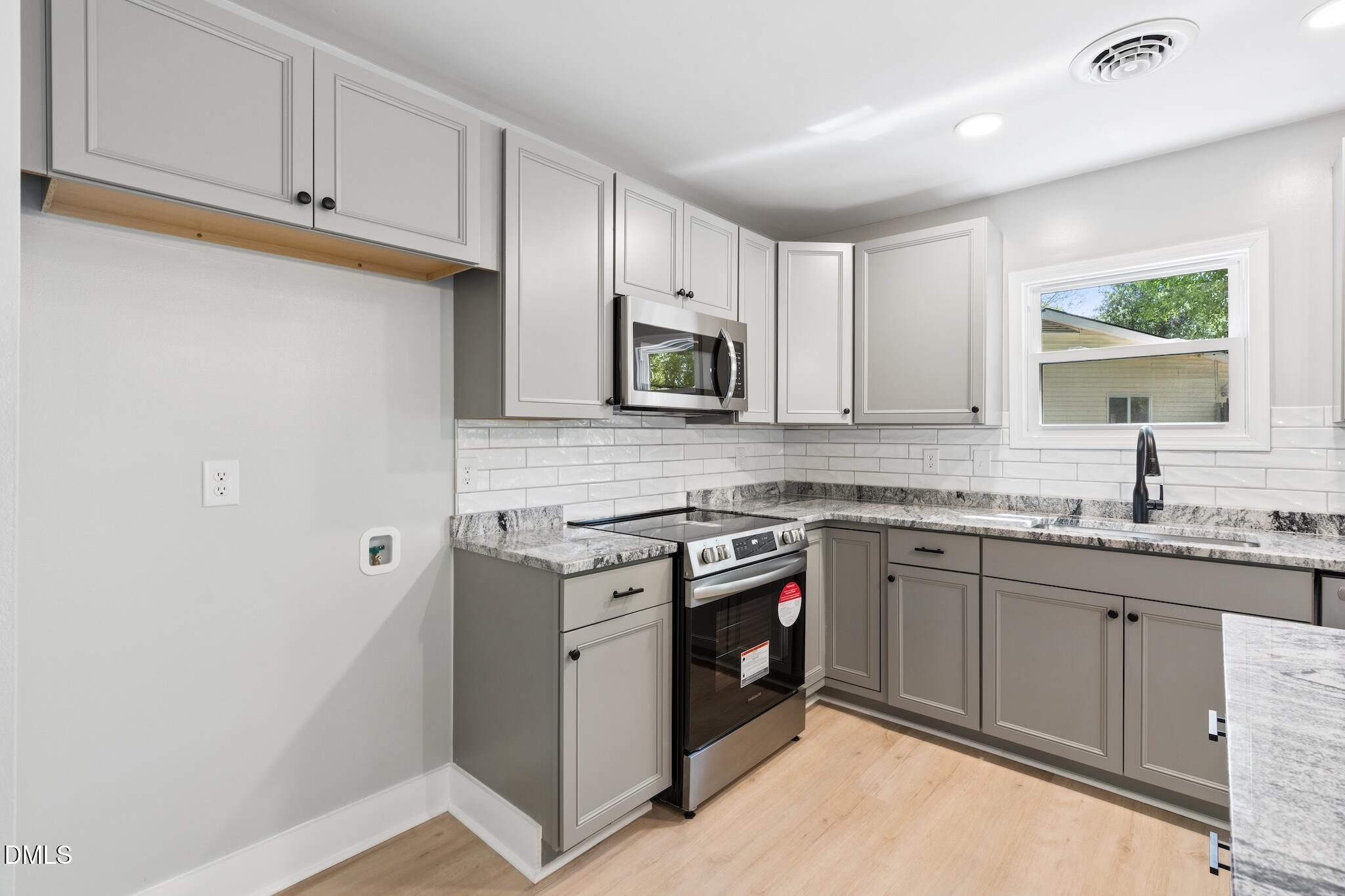 1200 Armstrong Circle Raleigh, NC 27610 - Photo 8 of 28 a kitchen with stainless steel appliances granite countertop white cabinets sink and a granite counter top