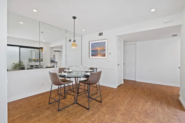 a view of a dining room with furniture window and wooden floor