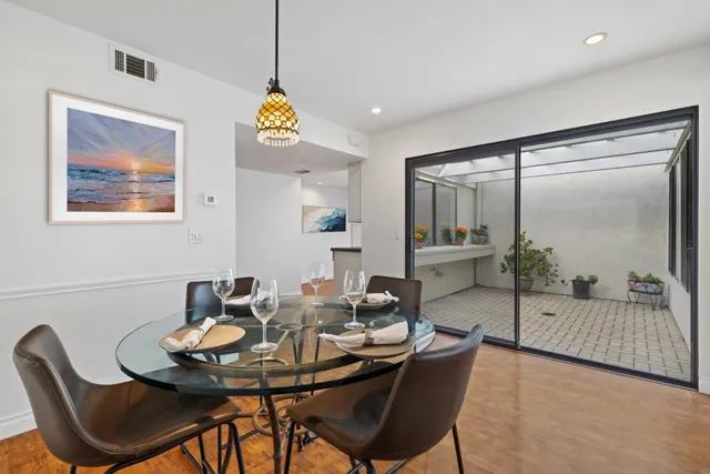 a view of a dining room with furniture window and wooden floor