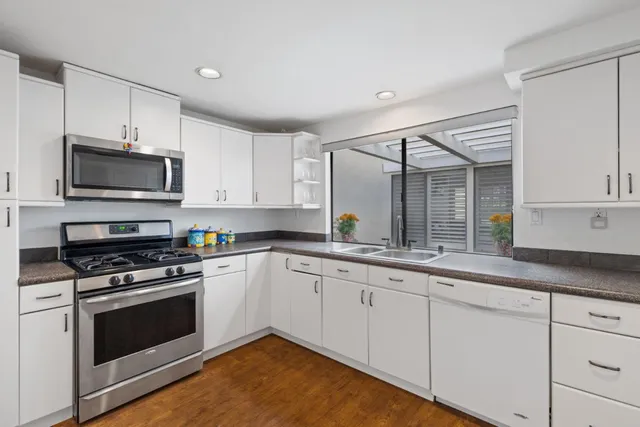 a en suite bathroom with a granite countertop sink and mirror